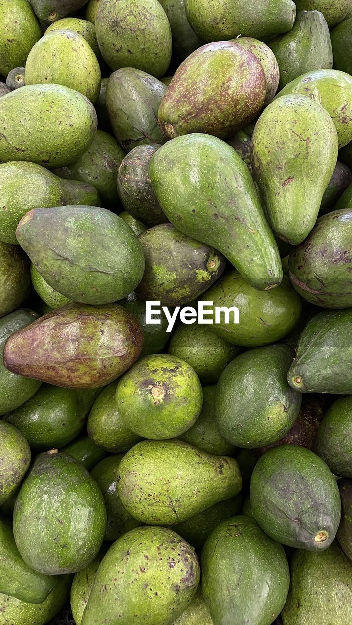 FULL FRAME SHOT OF GREEN FRUITS FOR SALE