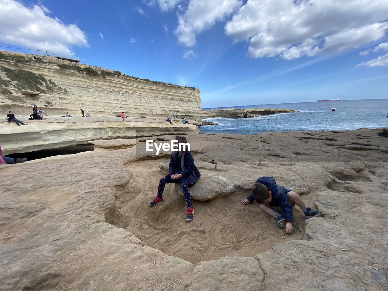 PEOPLE ENJOYING ON BEACH AGAINST SKY