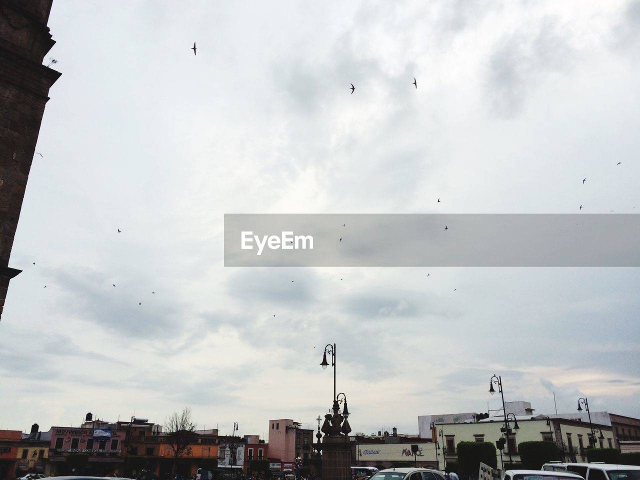 Buildings against cloudy sky in city