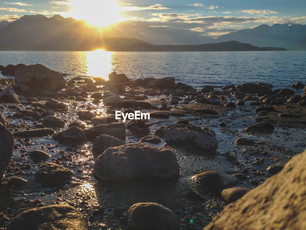 ROCKS IN SEA DURING SUNSET