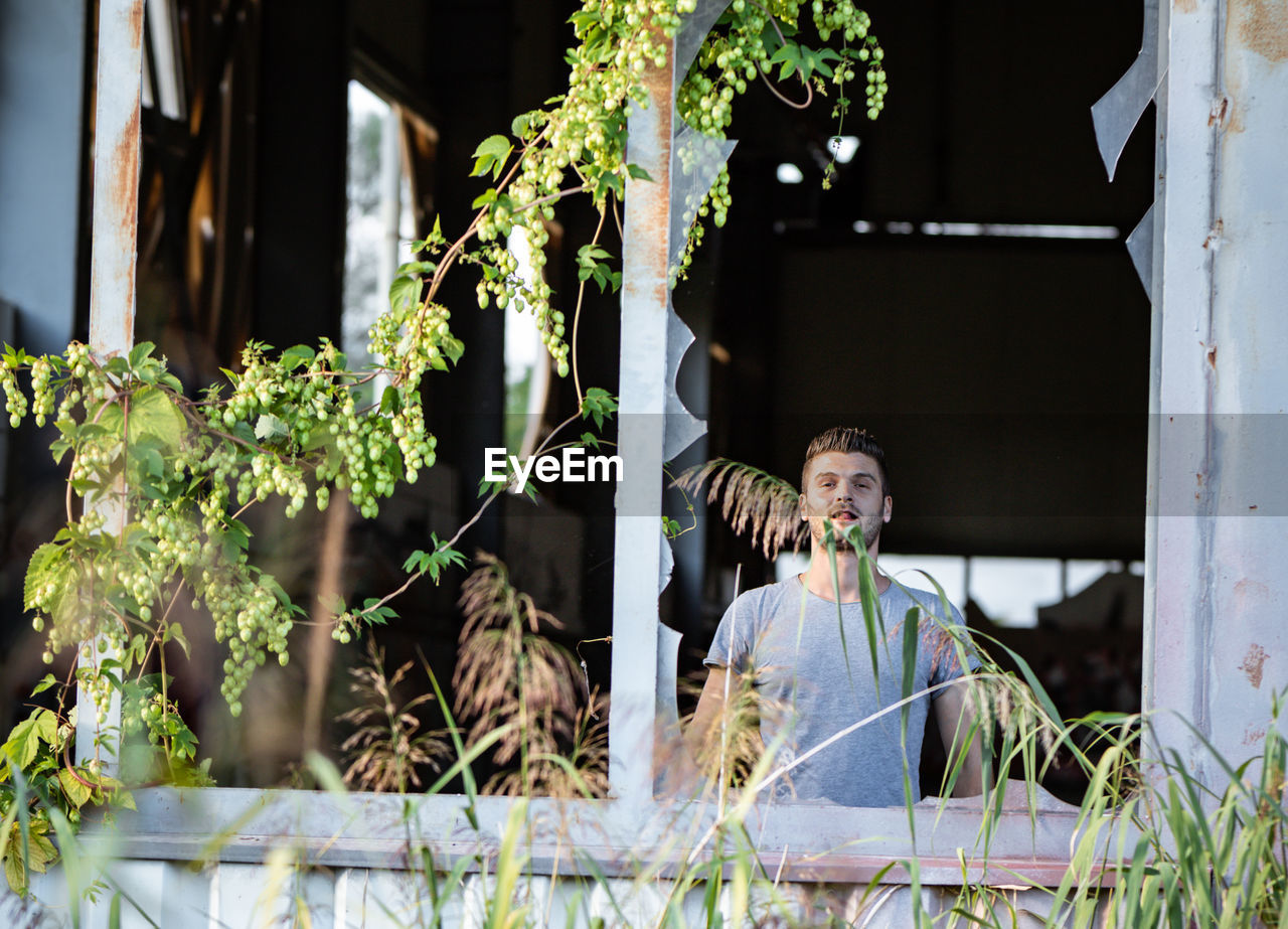 Portrait of man standing in abandoned building