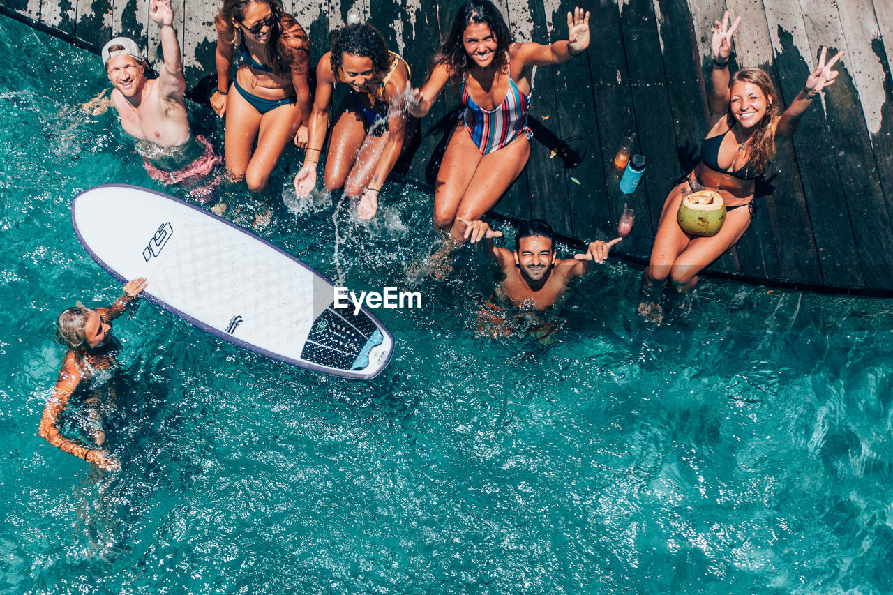 GROUP OF PEOPLE AT SWIMMING POOL