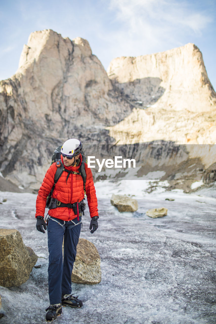 Mountaineer on the move below a mountain summit.