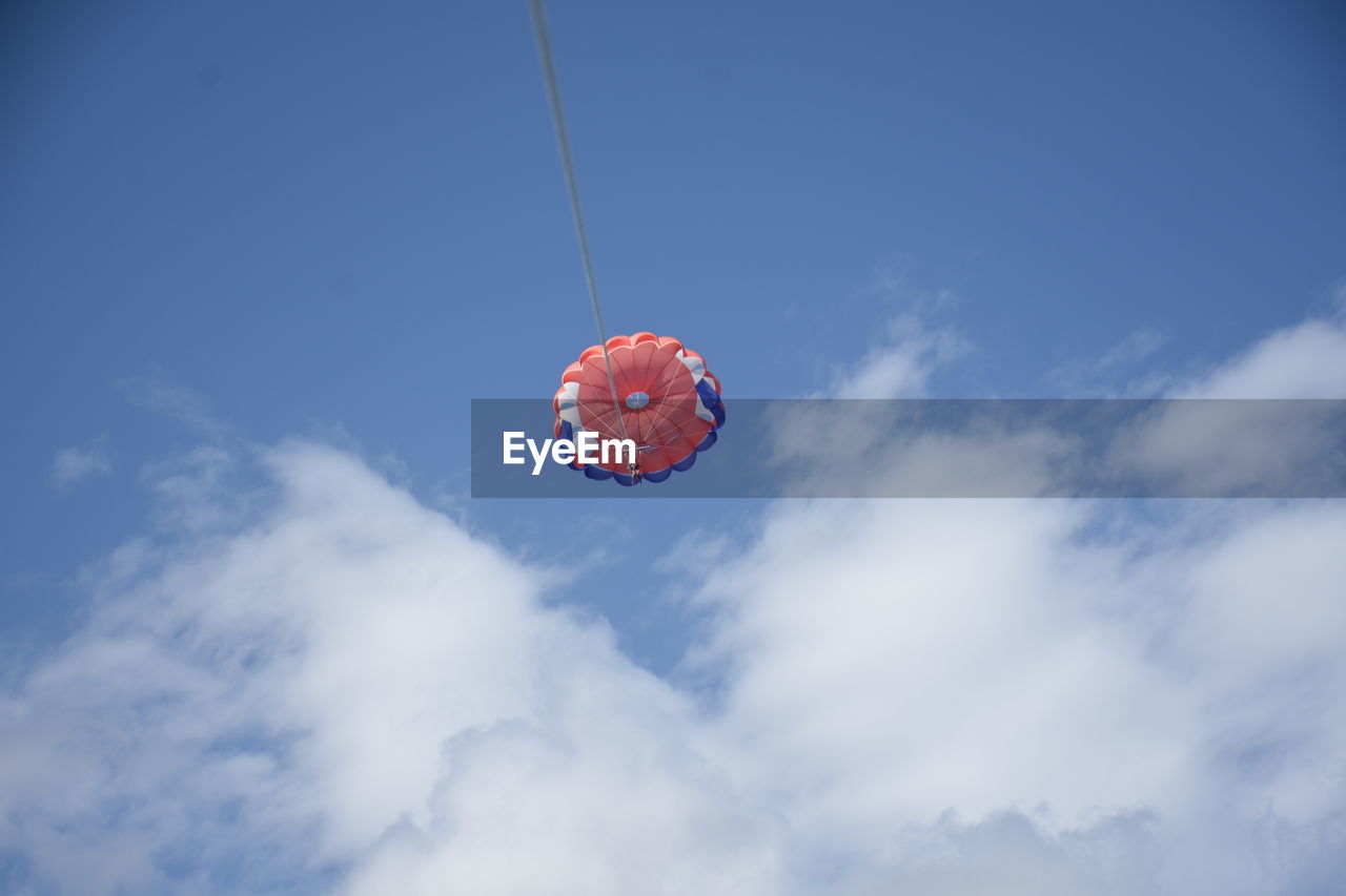 Low angle view of balloons flying against sky