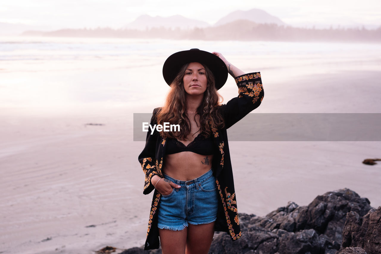 Beautiful, stylish woman on cox bay beach in tofino