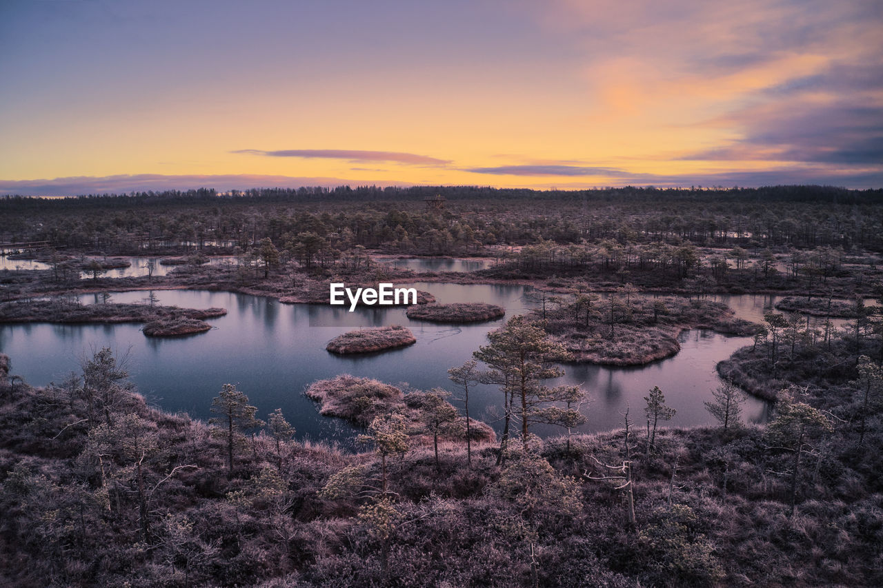 AERIAL VIEW OF LAKE AGAINST SKY DURING SUNSET