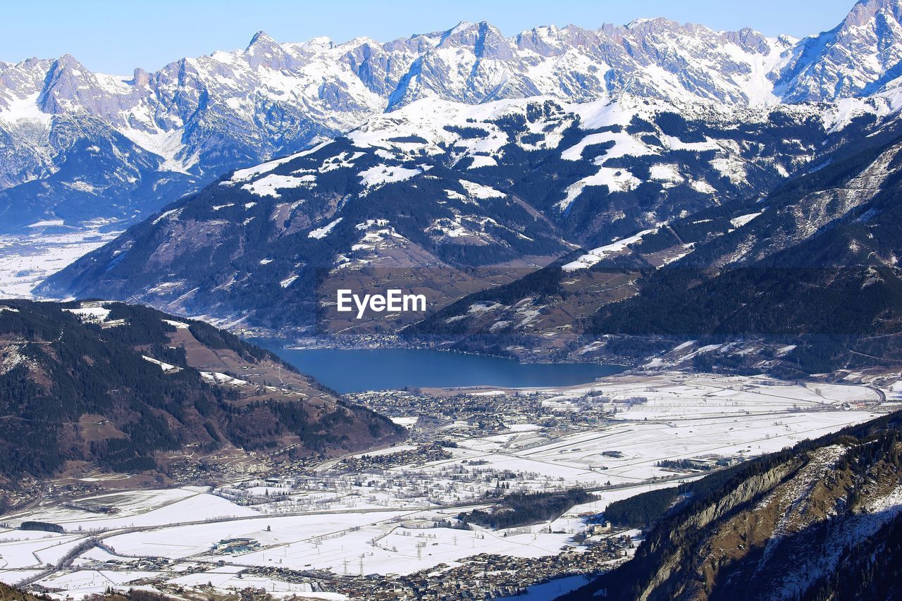 Aerial view of far zell am see lake among winter alp mountains in austria