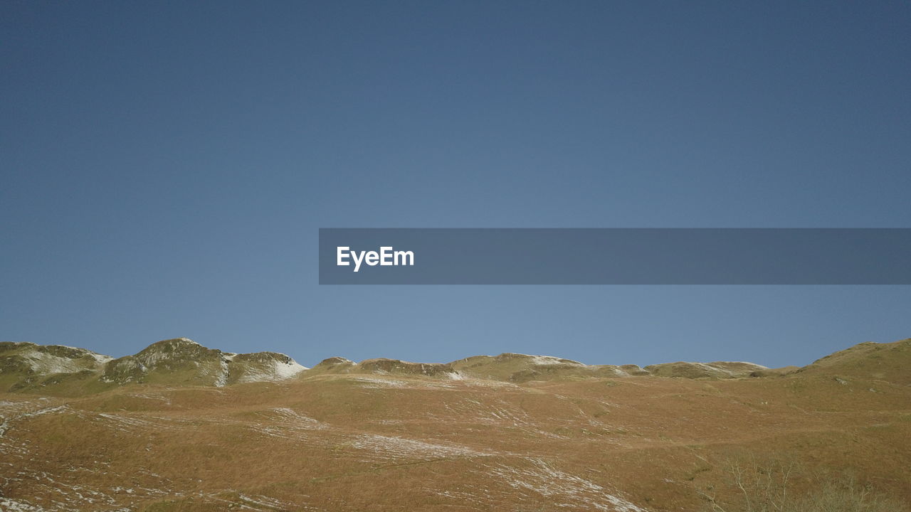 SCENIC VIEW OF MOUNTAINS AGAINST CLEAR SKY