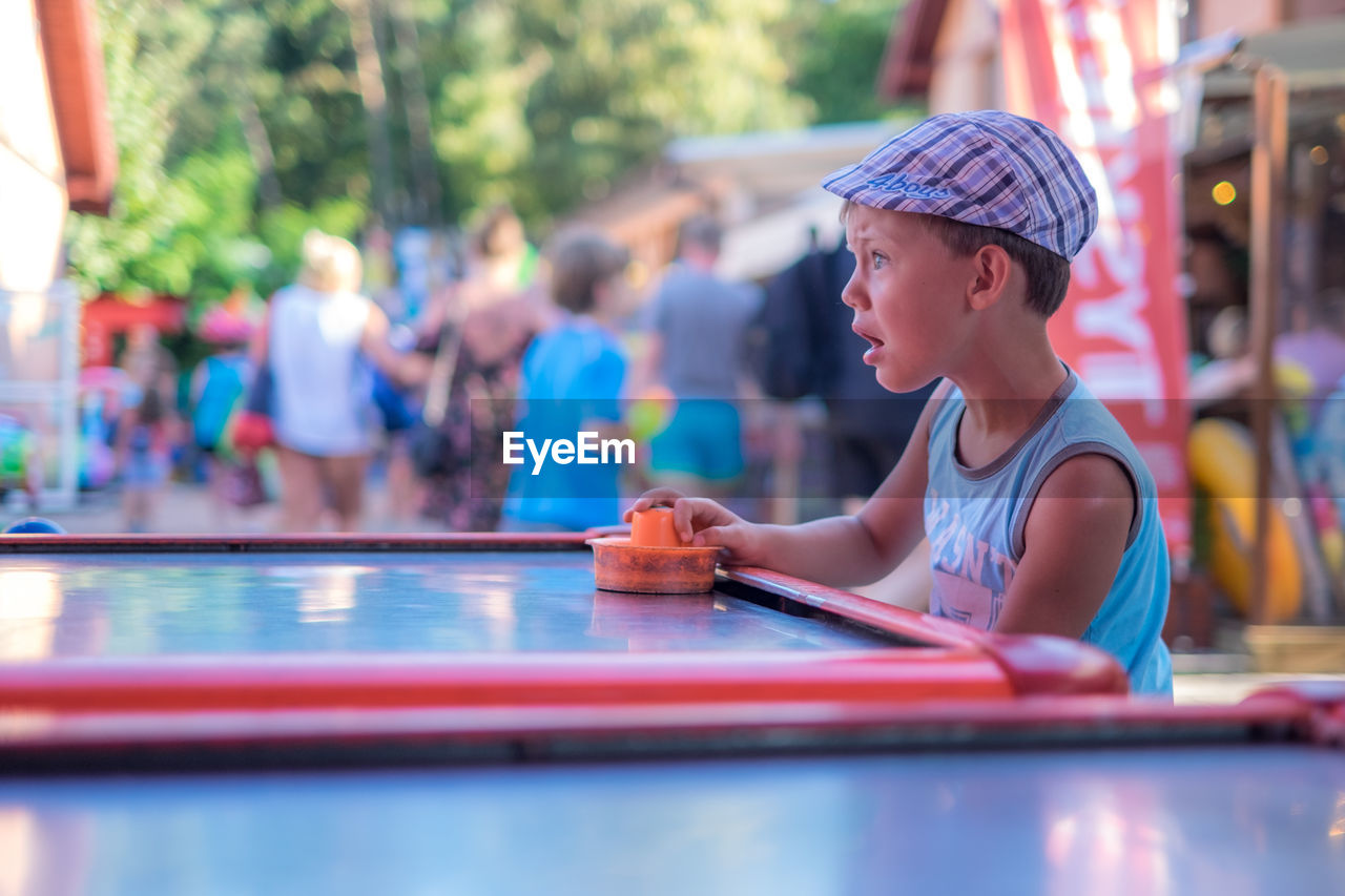 Boy playing air hockey