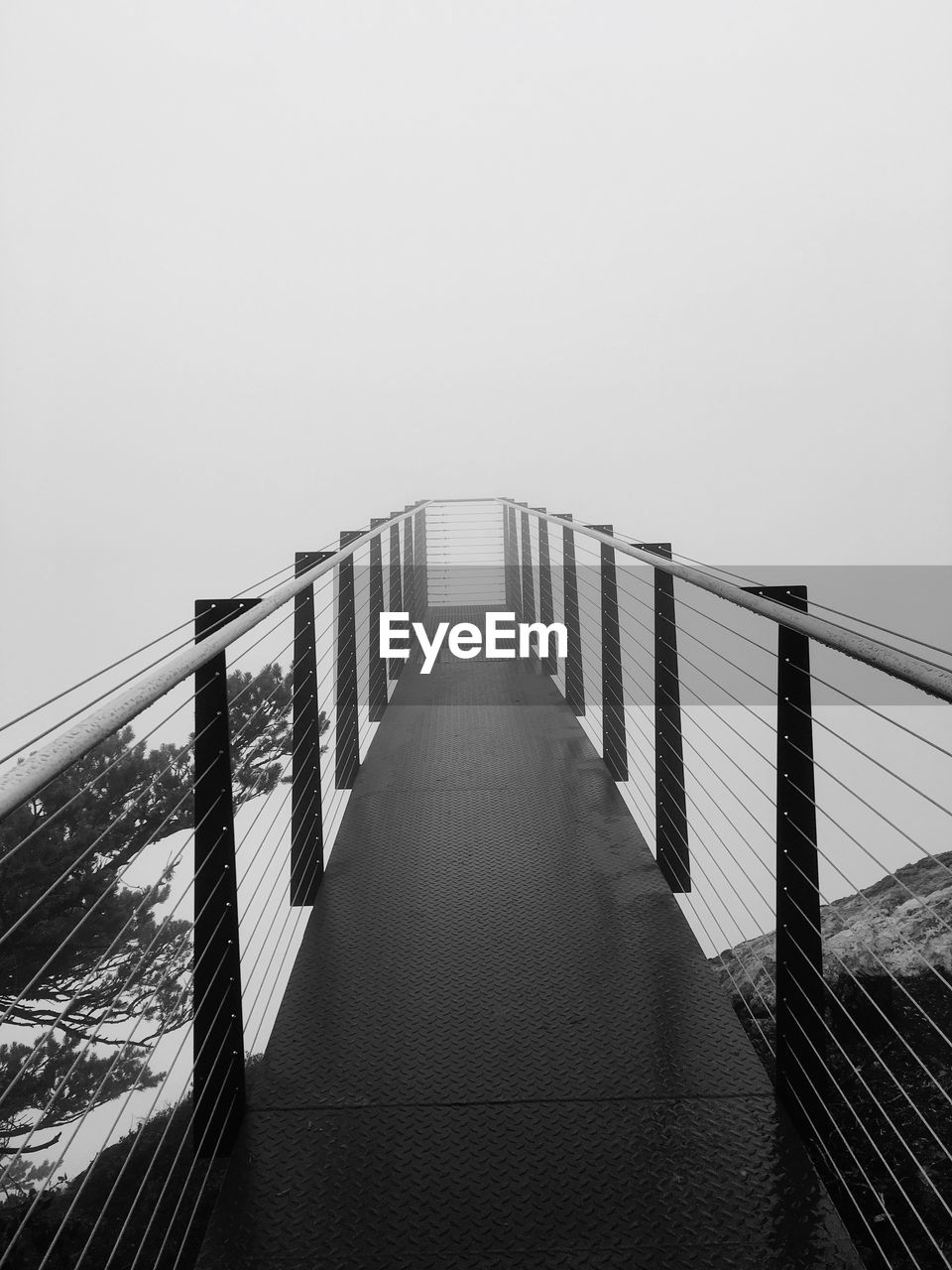 Footbridge against clear sky