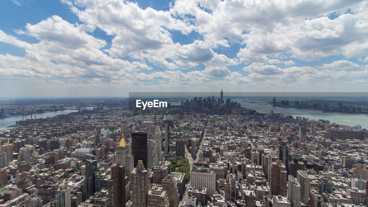 Panoramic view of sea and buildings against sky