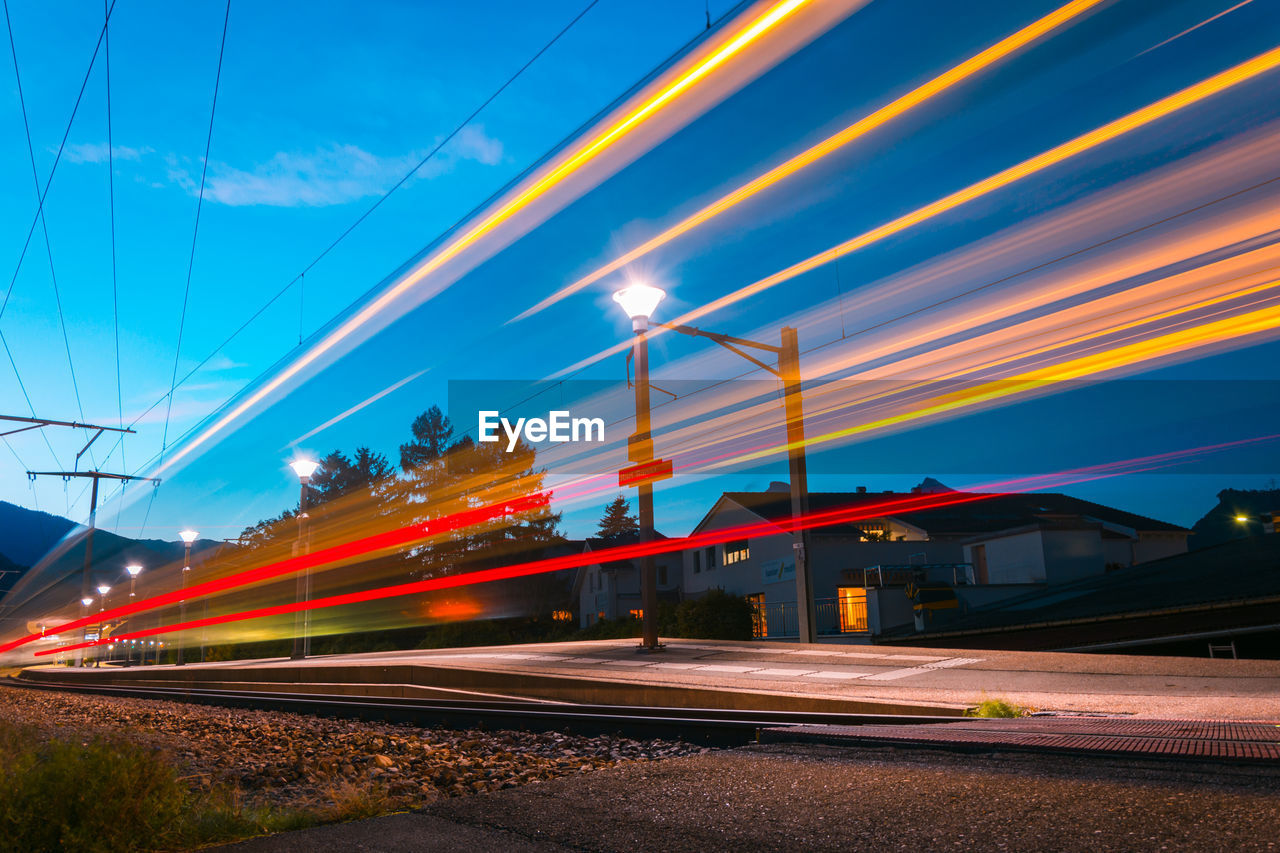 Light trails on road against sky in city