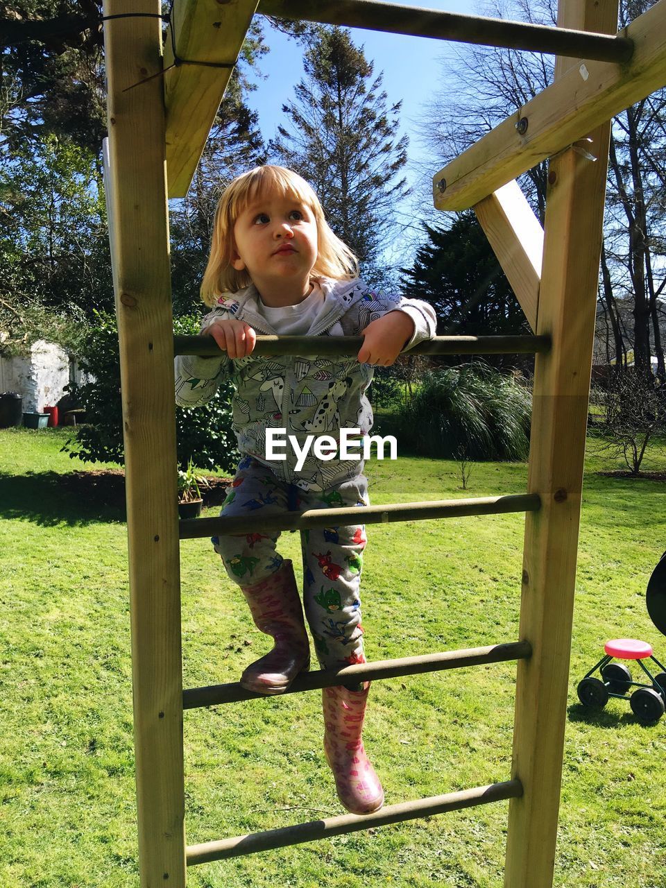 Girl climbing on jungle gym at park