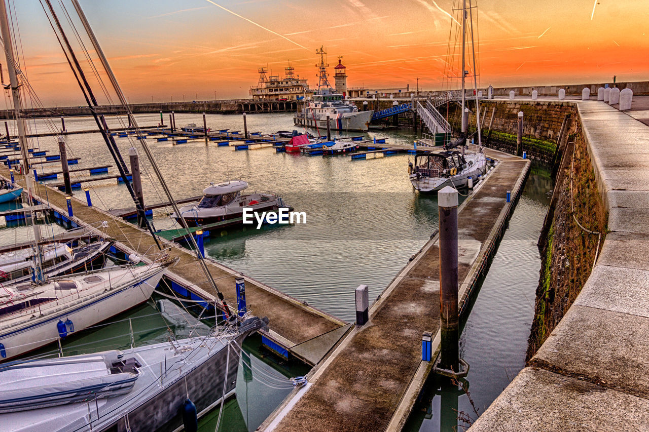 HIGH ANGLE VIEW OF SAILBOATS MOORED IN HARBOR