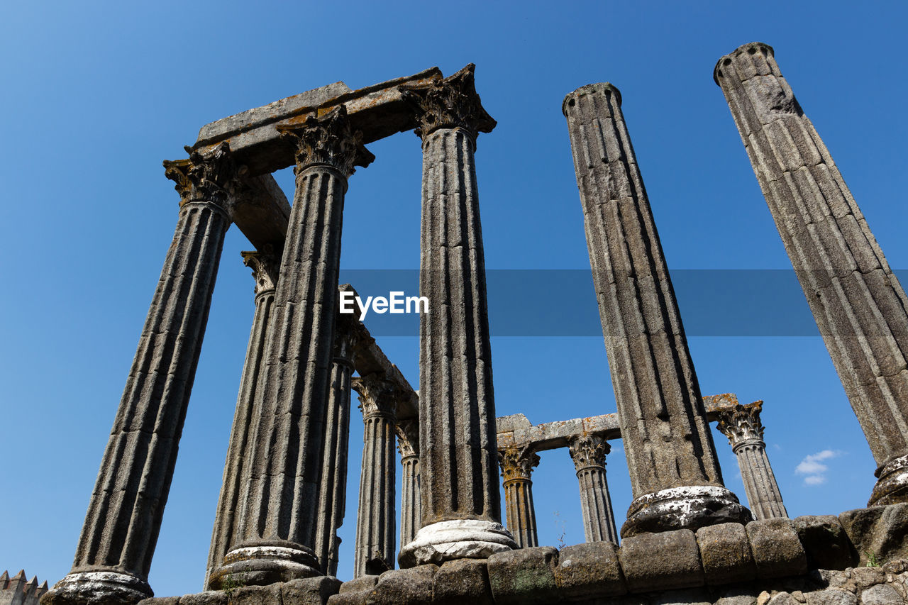 Low angle view of roman temple of evora against sky