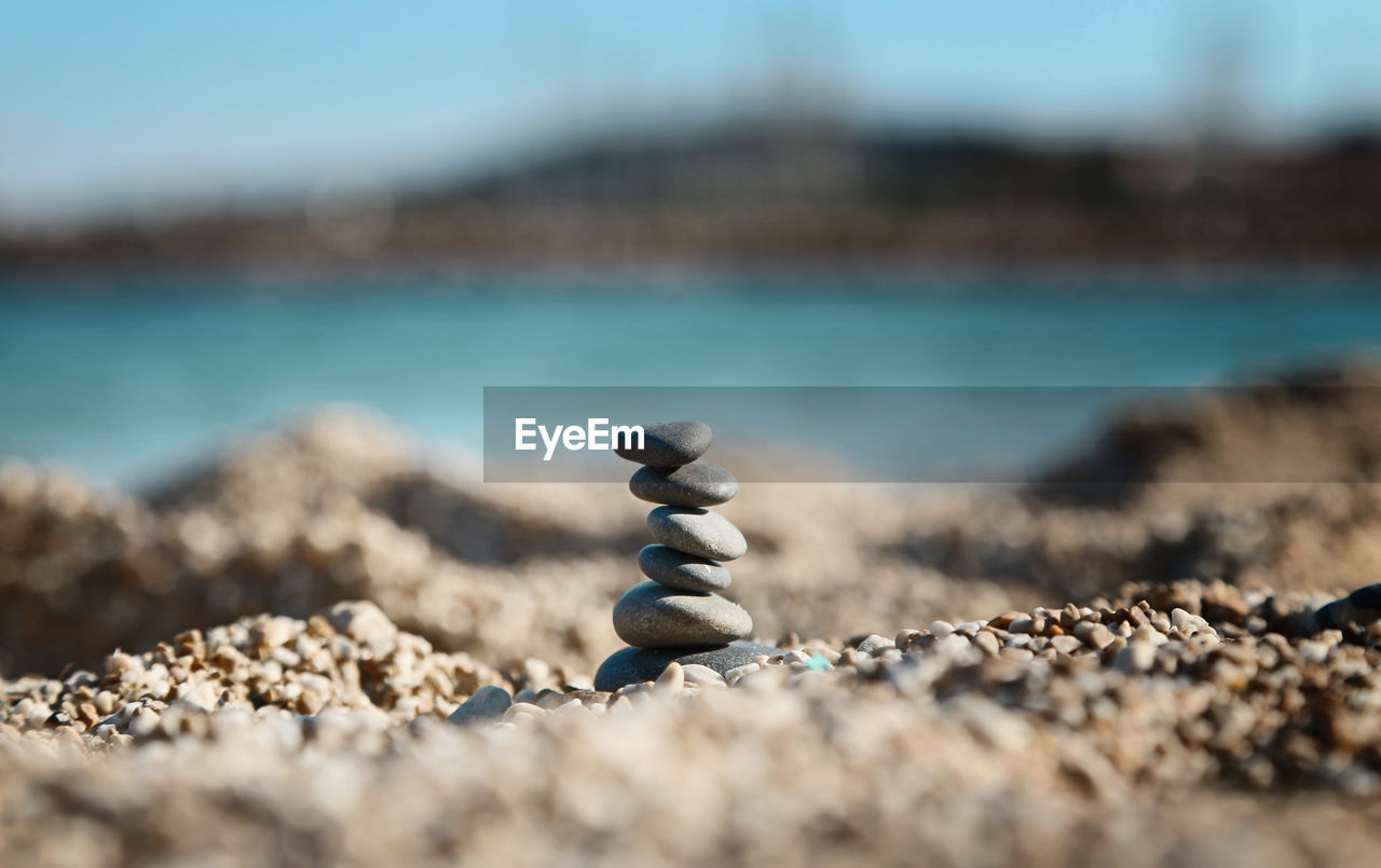Close-up of stacked pebbles at beach