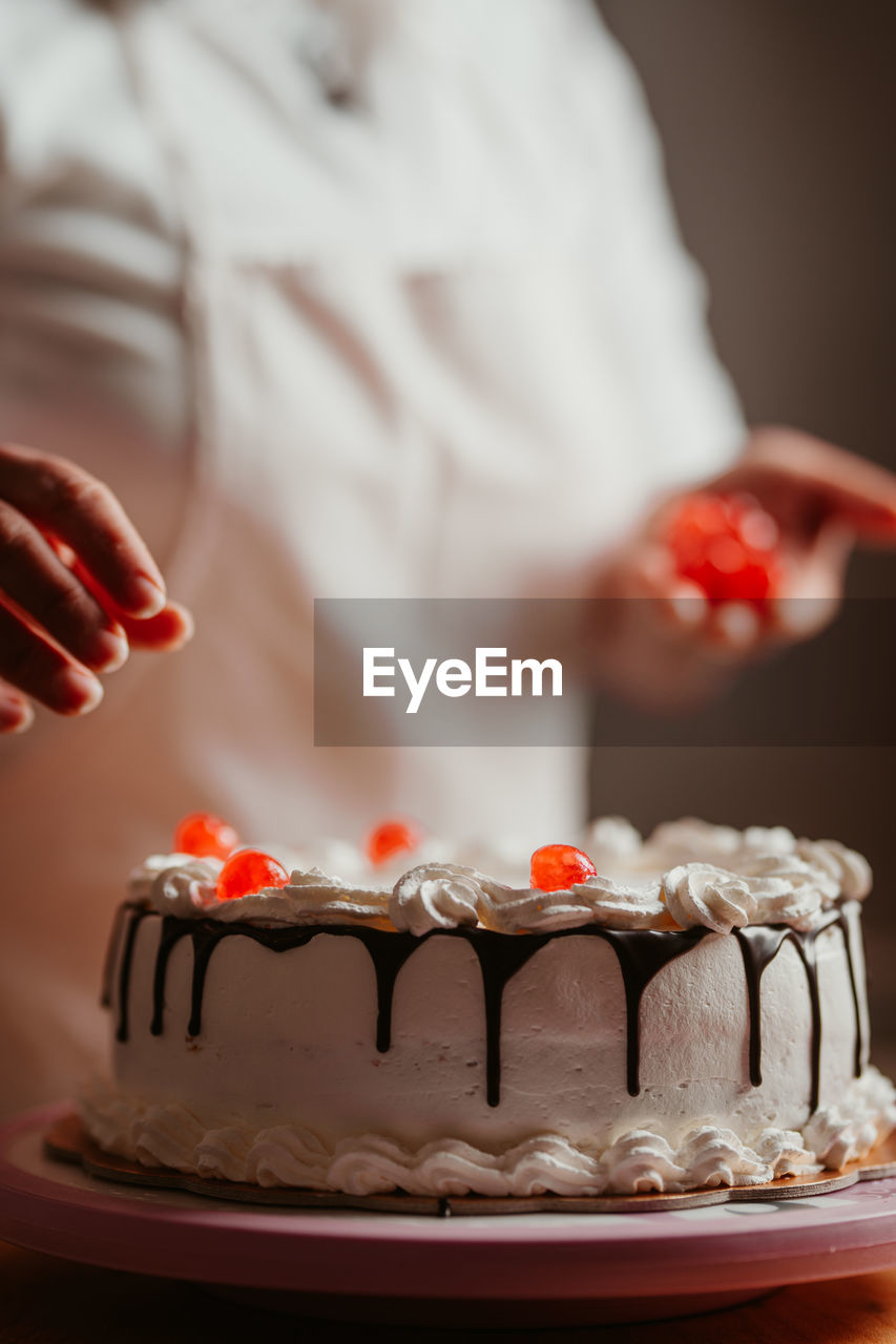 midsection of bride and cake