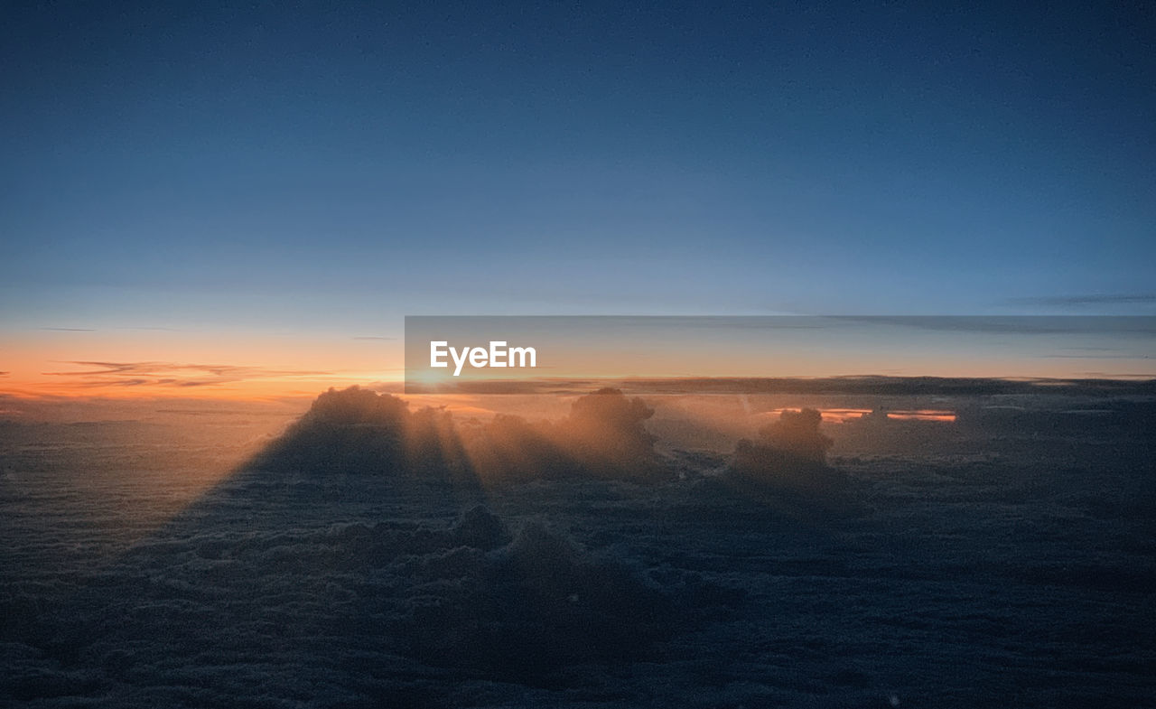 Above the clouds at 39.000 feet during sunset