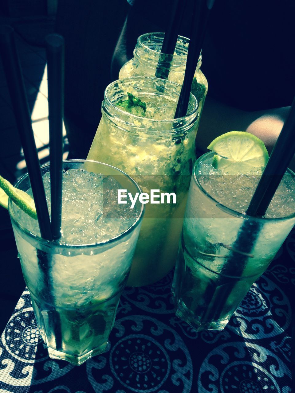 Close-up of mojito glasses on table