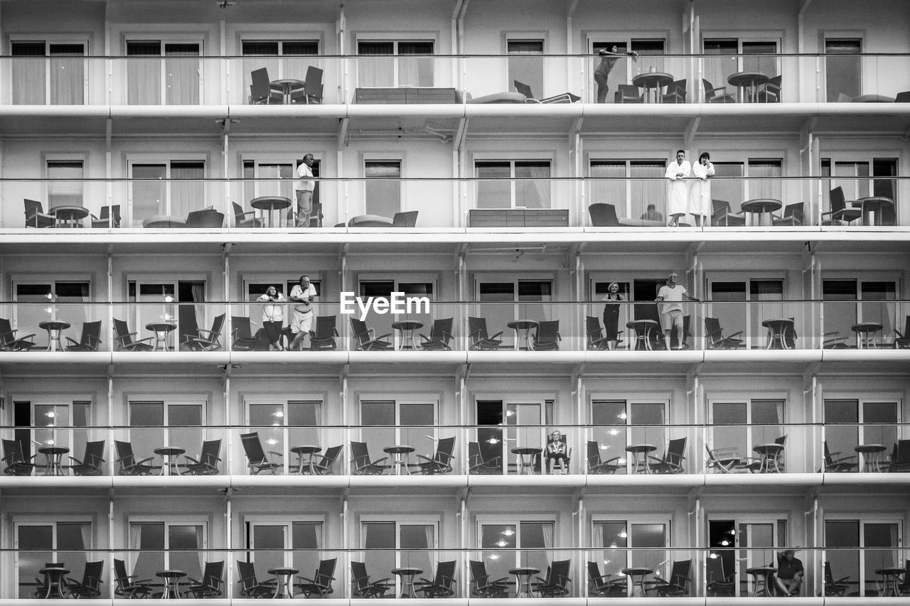 Full frame shot of cruise ship with people standing in balcony