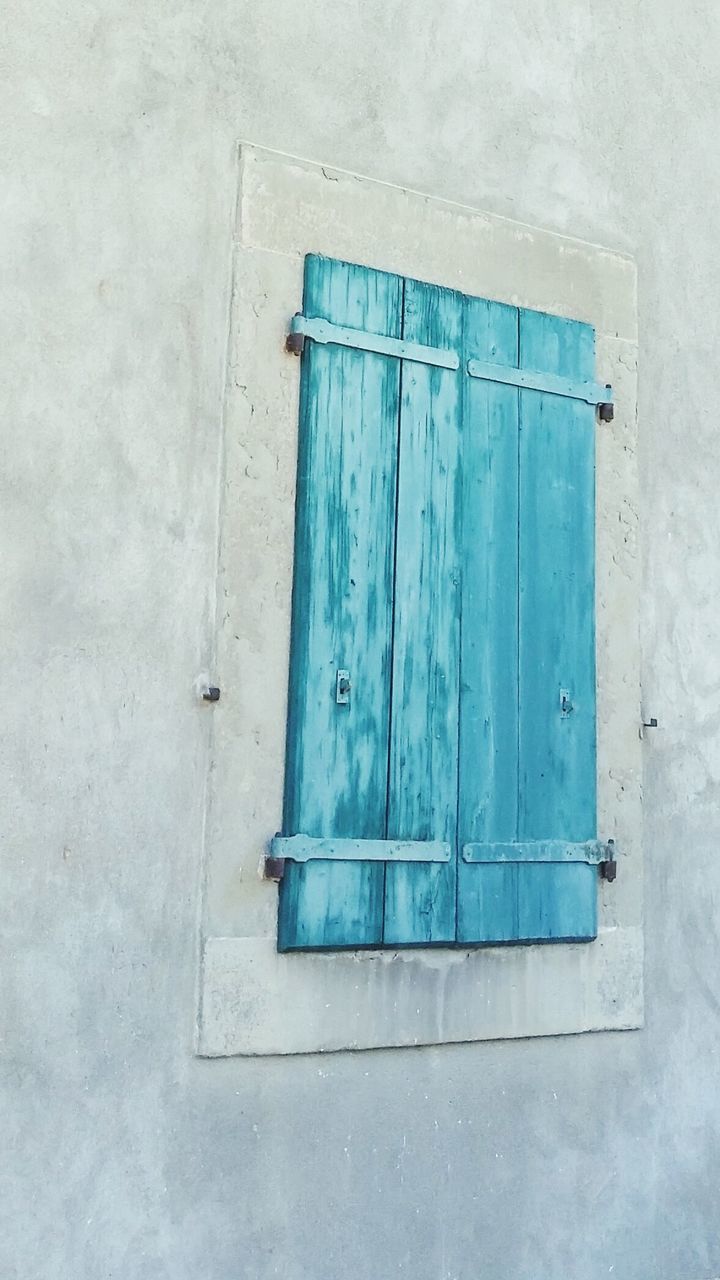 CLOSE-UP OF BLUE WINDOW ON WALL