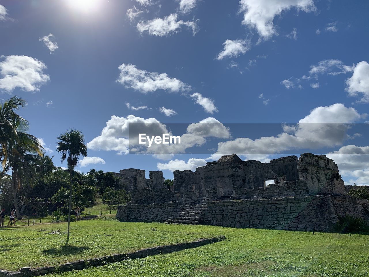 sky, plant, cloud, nature, architecture, tree, hill, travel destinations, landscape, environment, history, land, grass, travel, rural area, the past, ruins, no people, scenics - nature, tourism, built structure, ancient, outdoors, green, beauty in nature, sunlight, field, old ruin, building, day, blue, tranquility