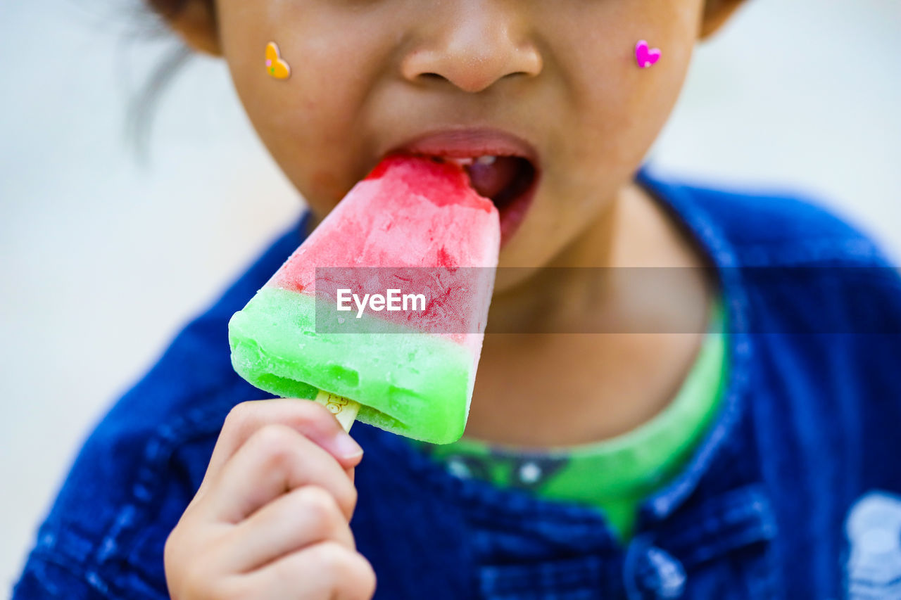 Midsection of woman eating ice cream
