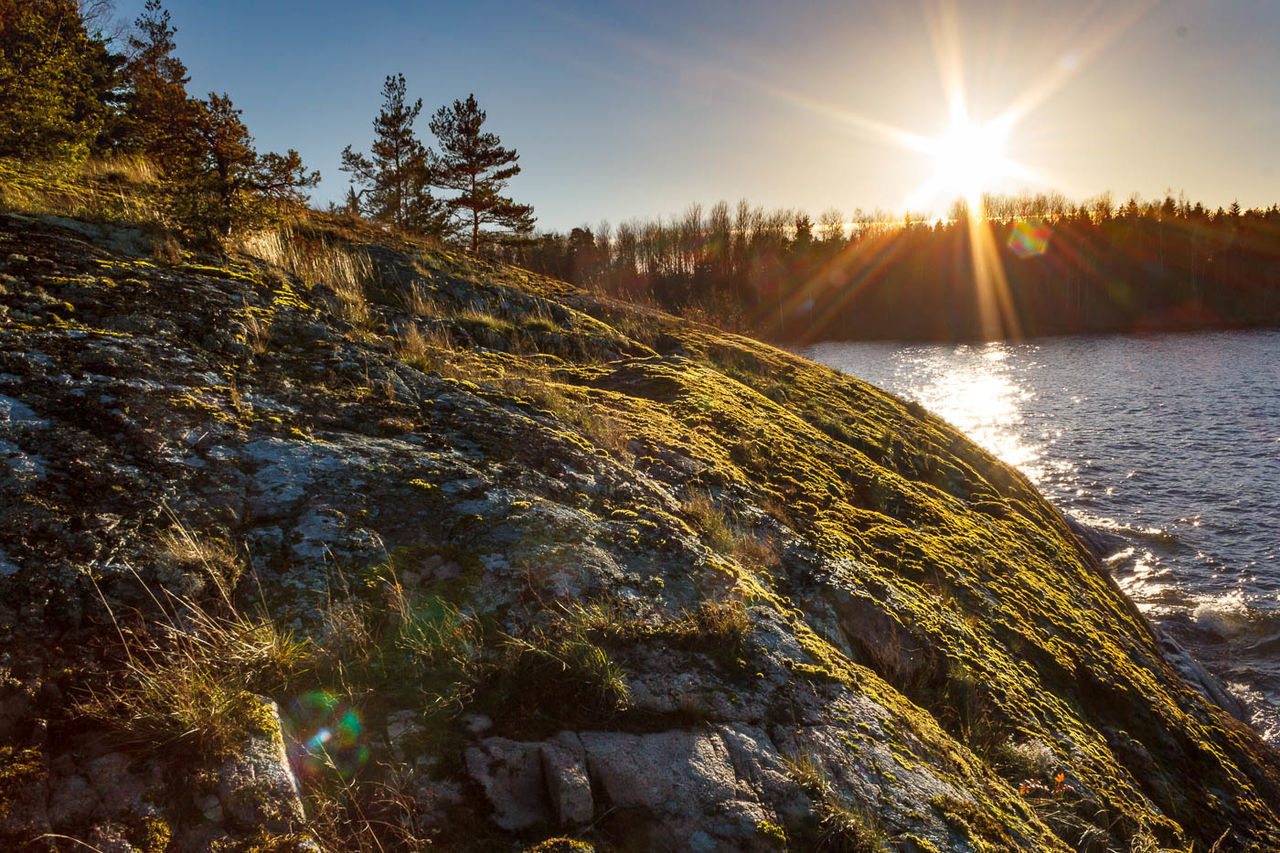 Sunlight shinning over mountains and river