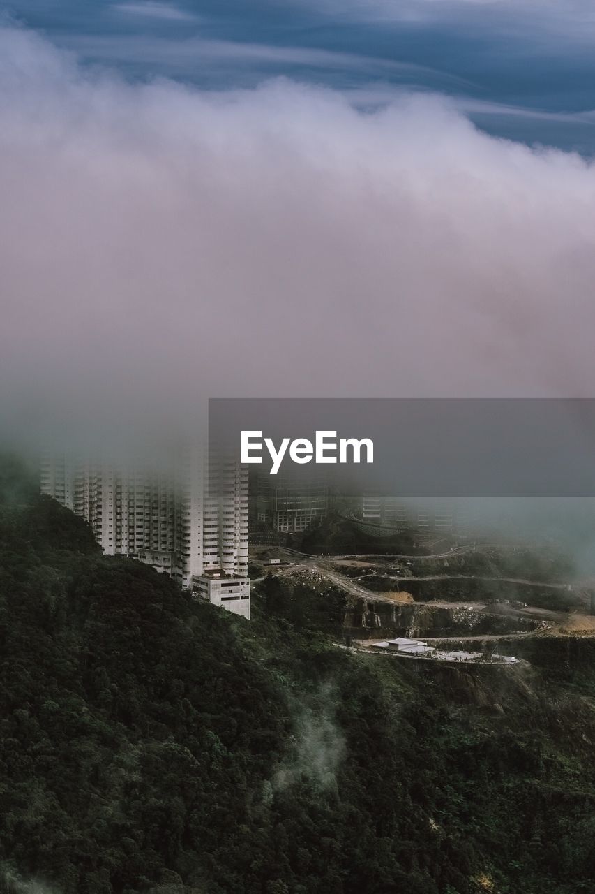 VIEW OF CITYSCAPE AGAINST CLOUDY SKY