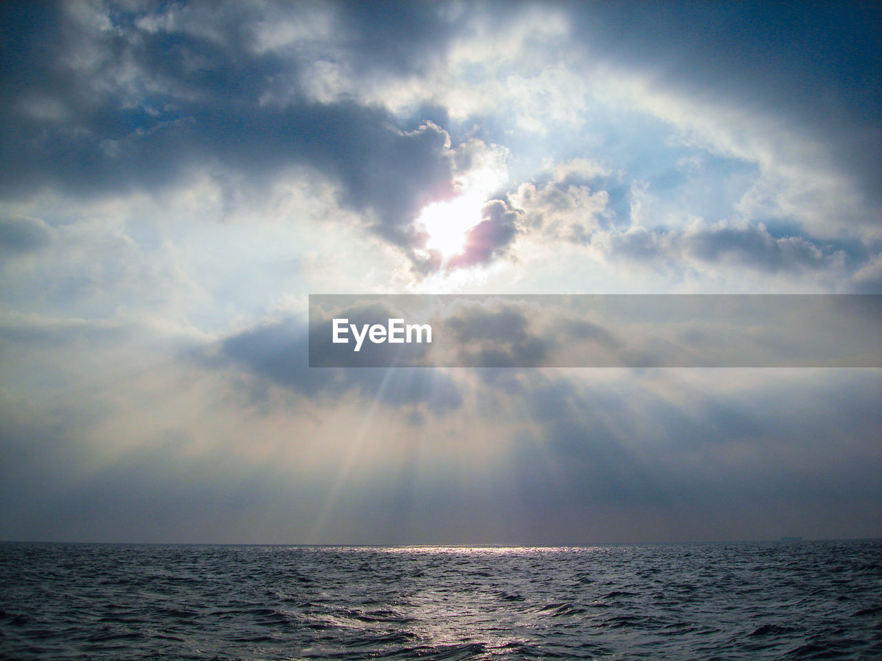 Scenic view of sea against storm clouds