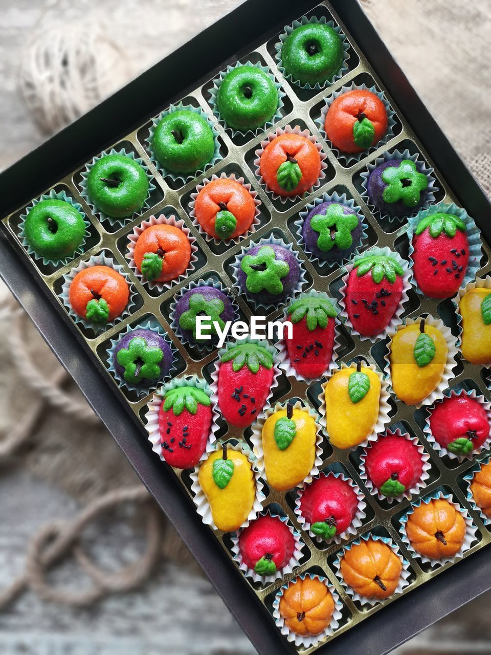 HIGH ANGLE VIEW OF MULTI COLORED CAKE ON TABLE