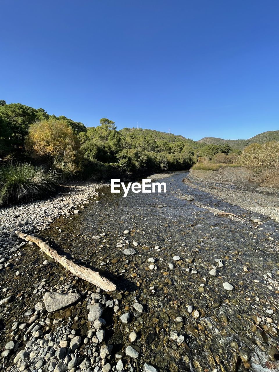 nature, rock, day, no people, sky, tree, plant, outdoors, blue, cliff, clear sky, terrain, beauty in nature, low angle view, land, sunlight, water, textured, reflection, tranquility, scenics - nature, geology