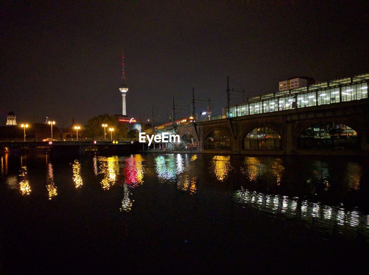 VIEW OF ILLUMINATED CITY AT NIGHT