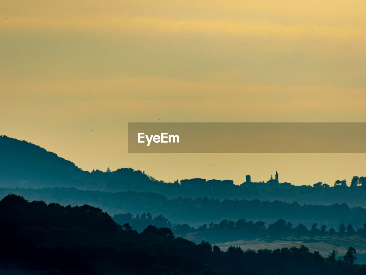 Scenic view of silhouette mountains against sky at sunset