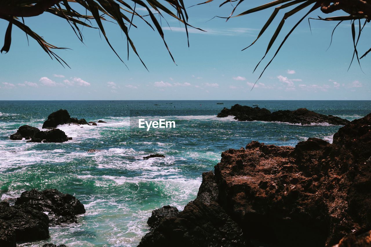 SCENIC VIEW OF SEA AGAINST SKY AT BEACH