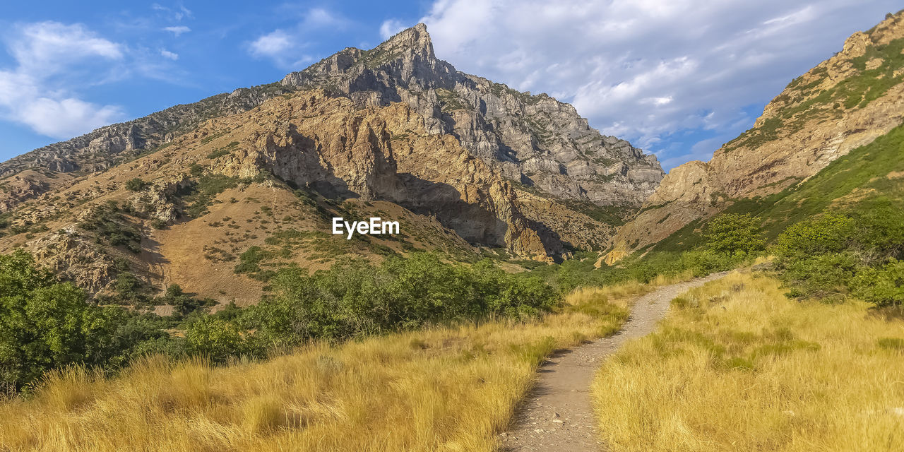 PANORAMIC VIEW OF MOUNTAINS AGAINST SKY