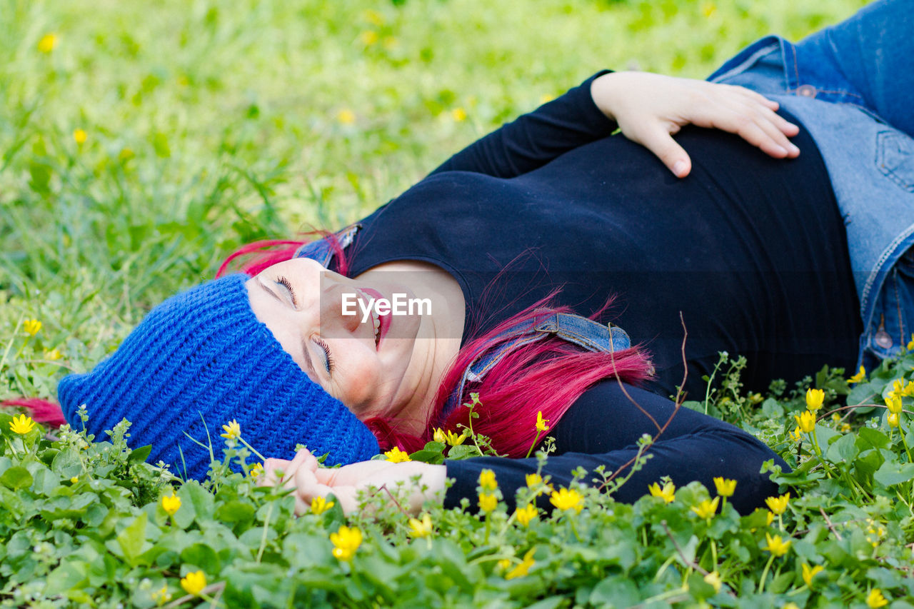 lying down, plant, relaxation, nature, adult, flower, one person, flowering plant, smiling, grass, lifestyles, happiness, person, emotion, lying on back, leisure activity, young adult, eyes closed, outdoors, women, casual clothing, resting, field, day, men, beauty in nature, meadow, plain, three quarter length, sleeping, clothing, lawn, growth, summer, portrait, child, freshness, tranquility, cheerful, enjoyment, human face, springtime, green