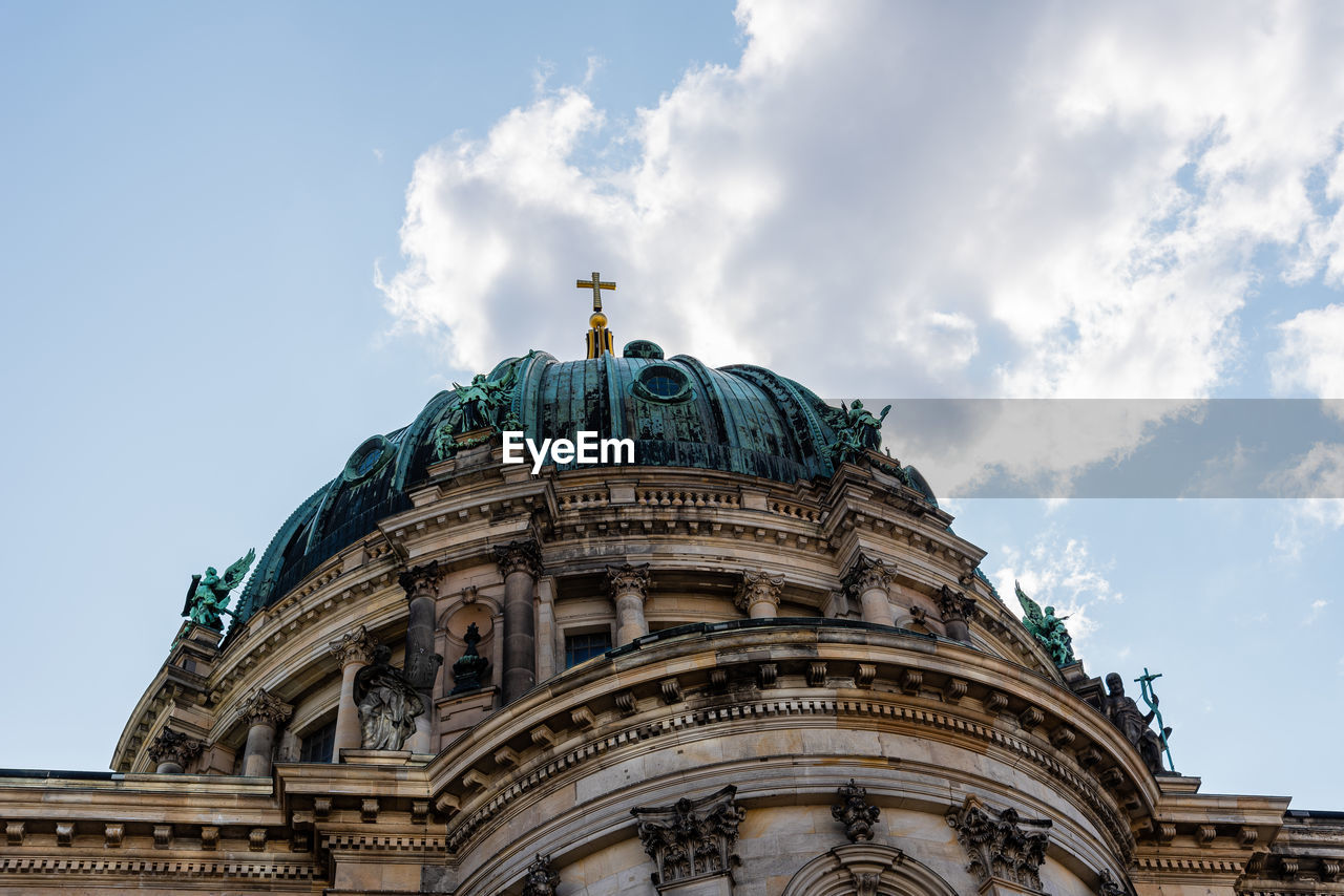 Low angle view of the dome of berlin cathedral, berliner dom, against blue sky with clouds