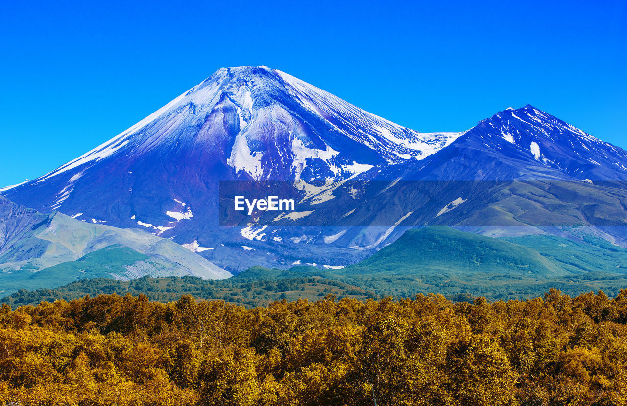 The avachinsky volcano in kamchatka in the autumn with a snow-covered top