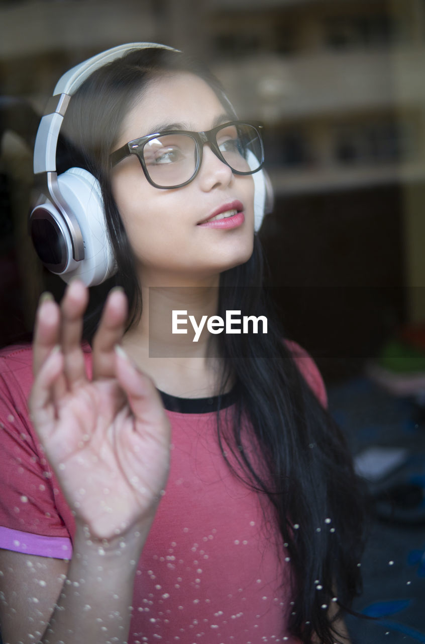 Portrait of young woman with camera