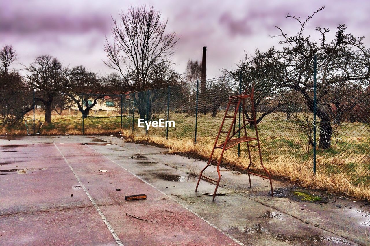 View of abandoned playground against bare trees