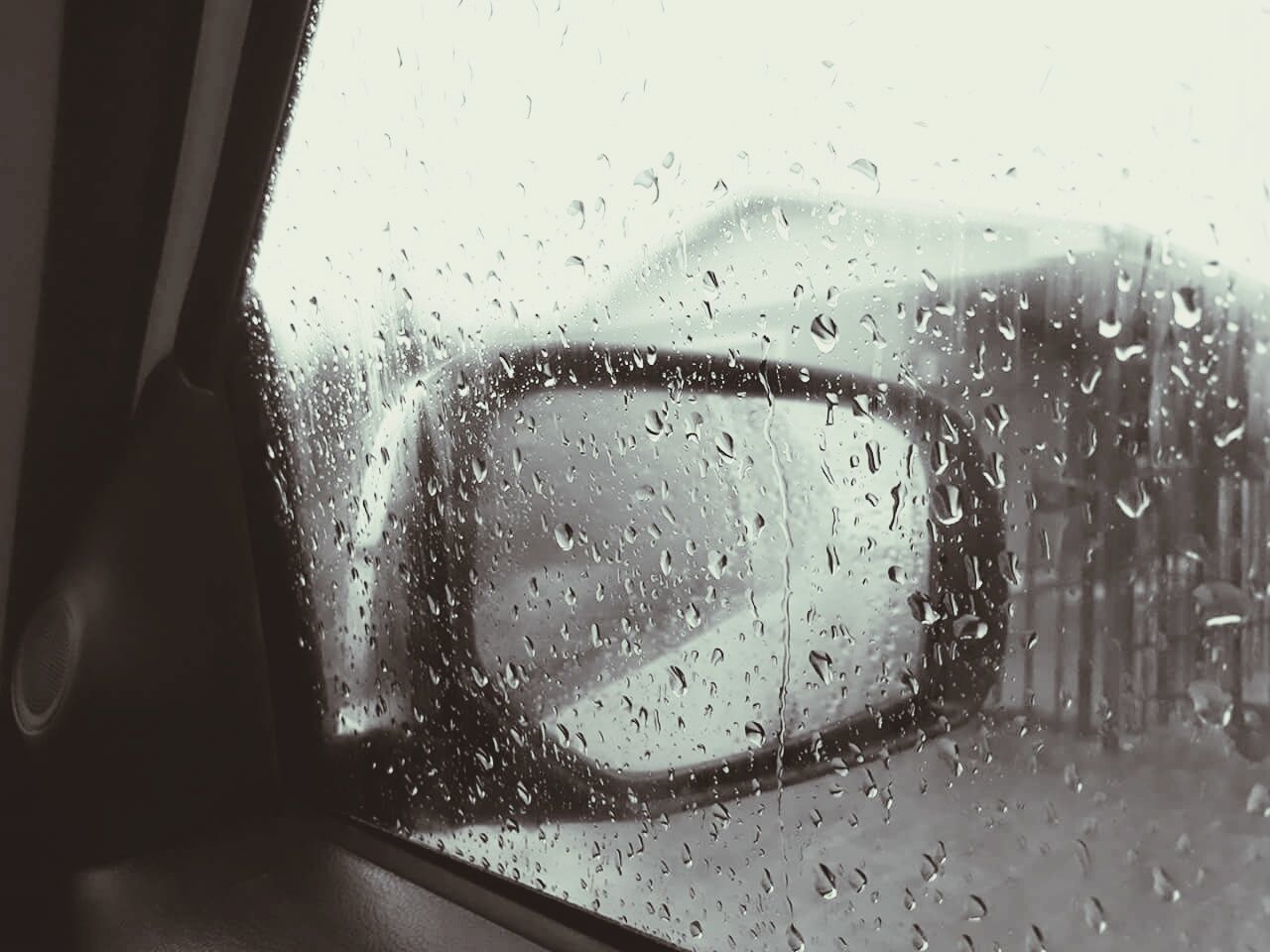 Close-up of wet car window in rainy season