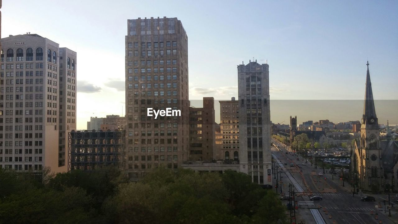 Exterior of buildings in city against sky during sunset