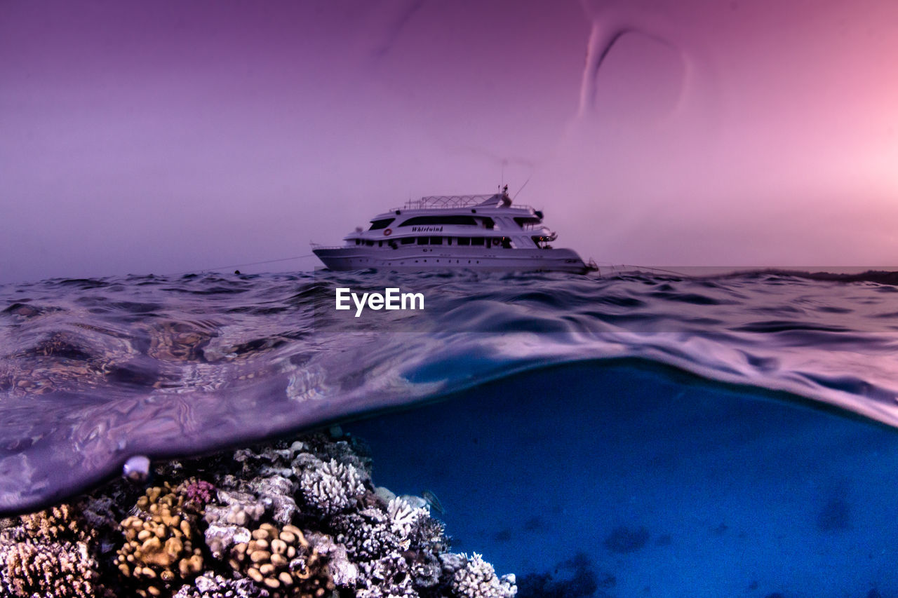 SCENIC VIEW OF ROCKS AT SEA AGAINST SKY