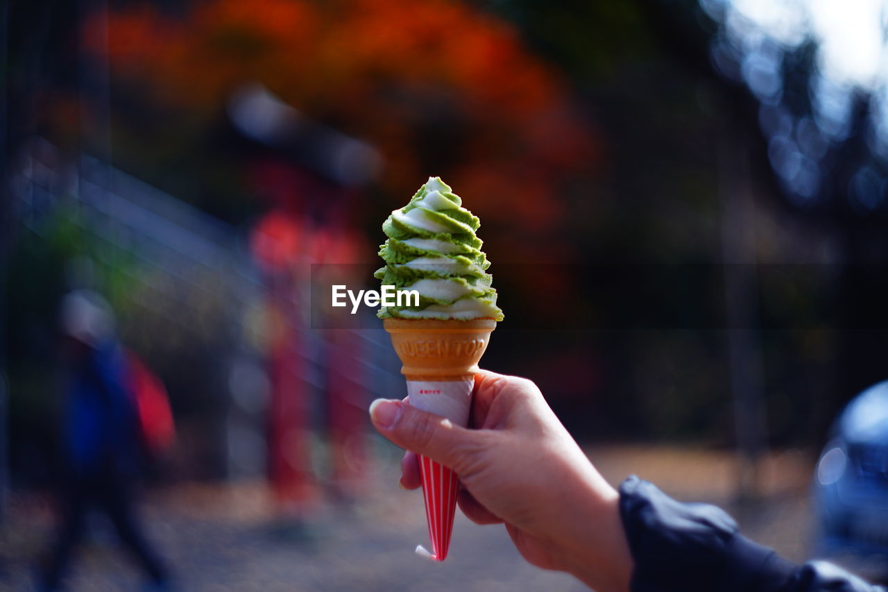 Close-up of hand holding ice cream