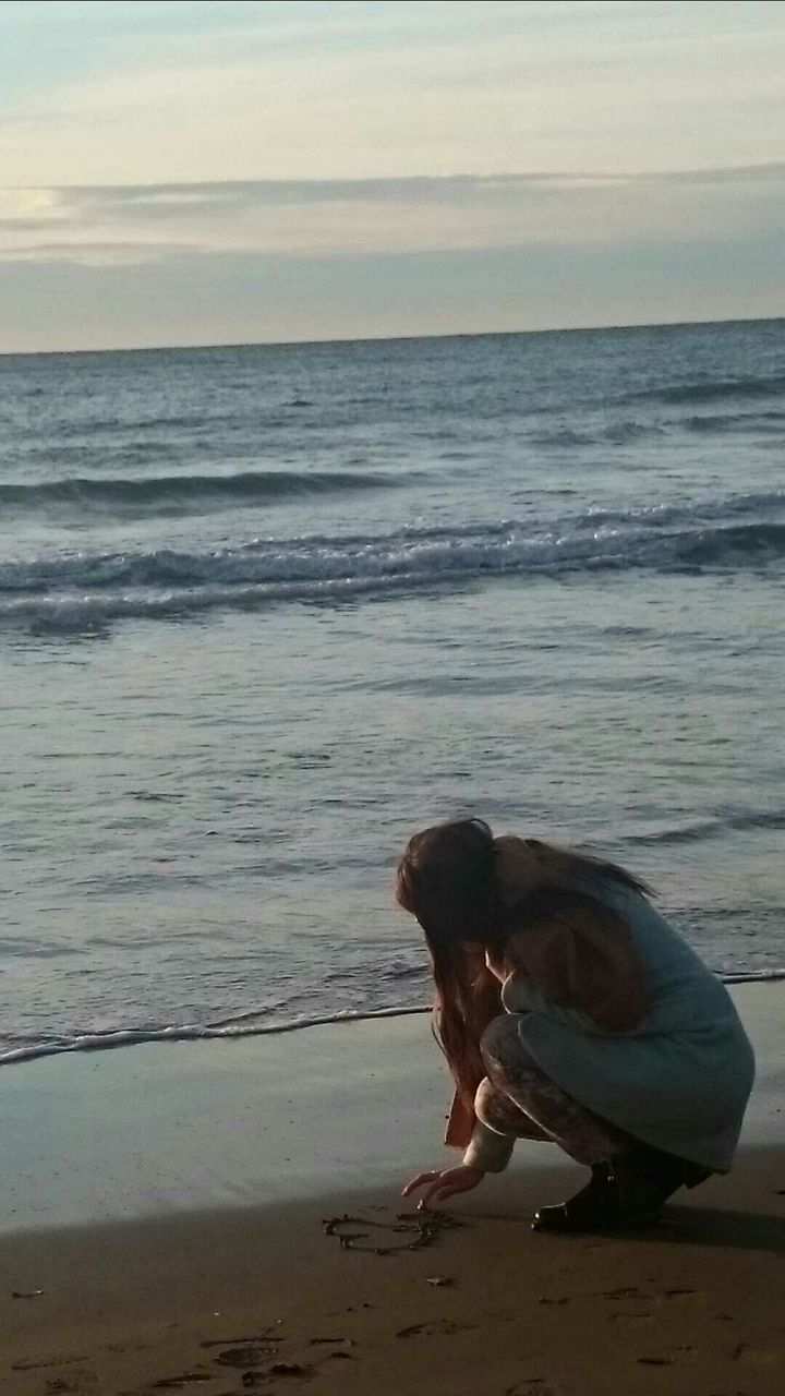 VIEW OF DOG STANDING ON BEACH