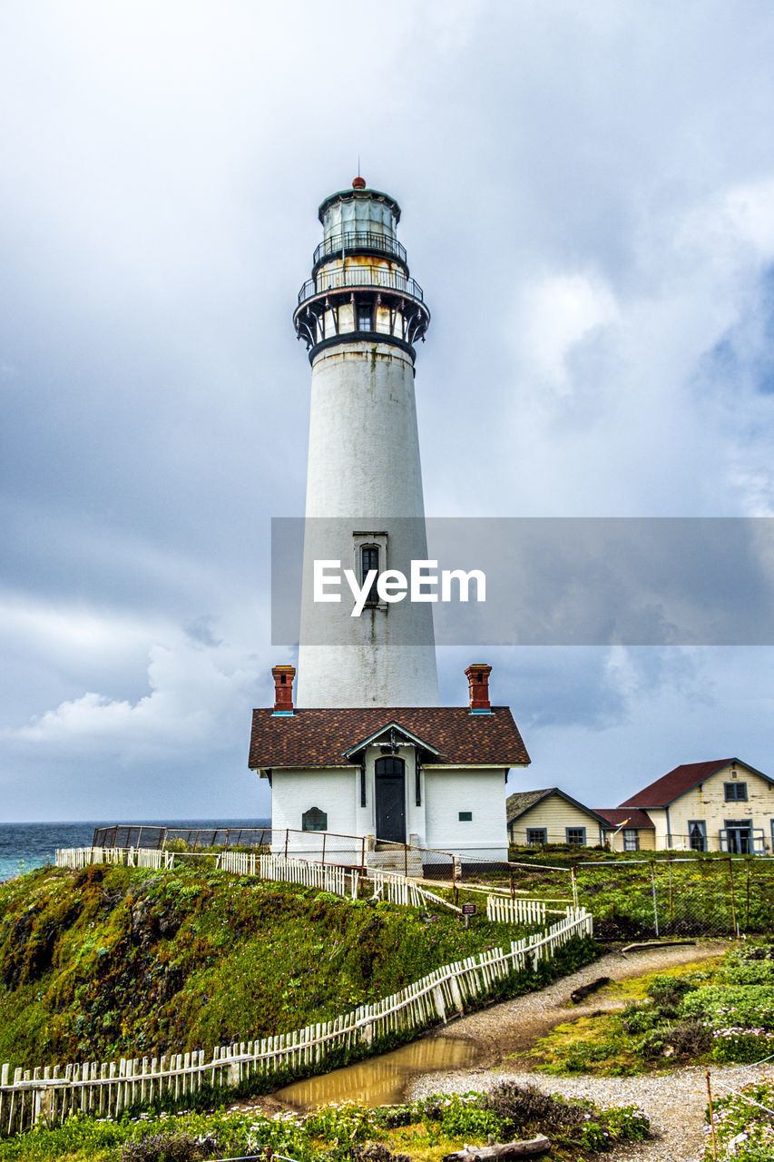 LIGHTHOUSE AGAINST SKY AND BUILDING