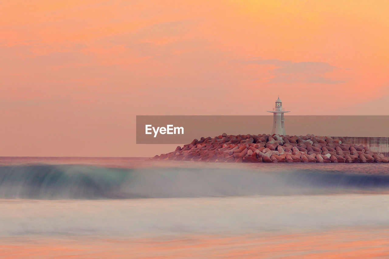 Scenic view of sea against sky at sunset