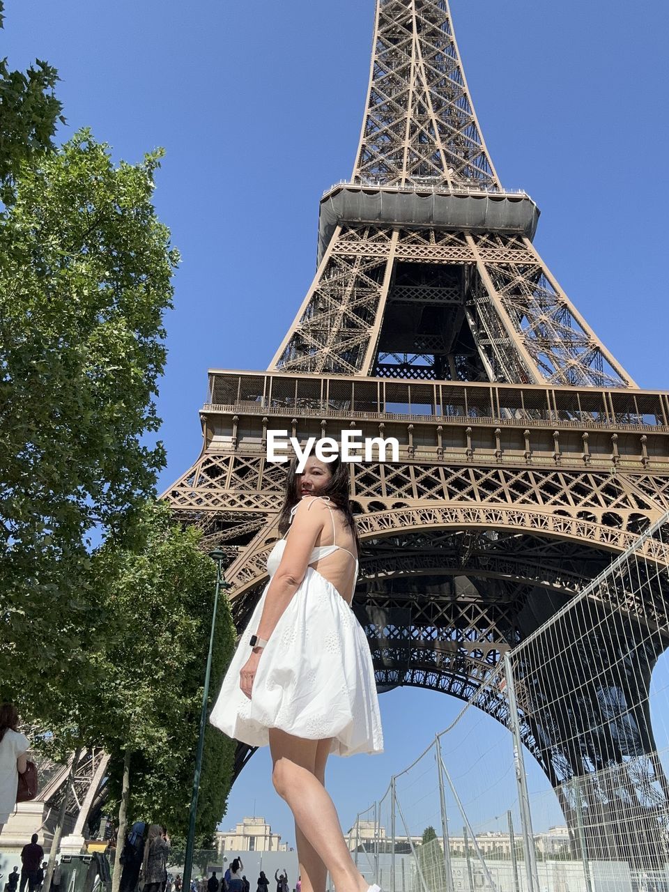 Low angle view of woman standing against sky