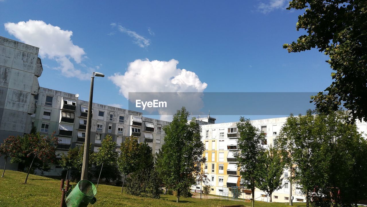 PANORAMIC VIEW OF TREES AND BUILDINGS AGAINST SKY